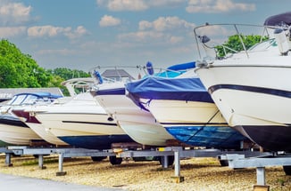Various boats sit on lot to be sold while being helped by marine marketing agency