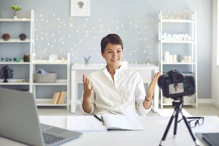 Woman explaining her reasons to use video marketing on camera
