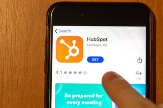 Person downloading HubSpot on phone to discover what is HubSpot used for