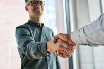 Smiling man shaking hand after discussing inbound marketing solutions